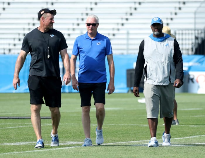 Dan Campbell, Rod Wood and Brad holmes walk on the field
